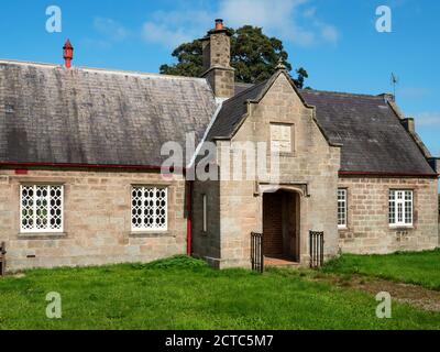 Former village school building which houses the village hall in the left hand side Little Ribston near Knaresborough North Yorkshire England Stock Photo
