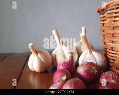 Ripe and raw organic onion and garlic on wooden background, alternative medicine, organic cleaners. Onions and garlics background Stock Photo