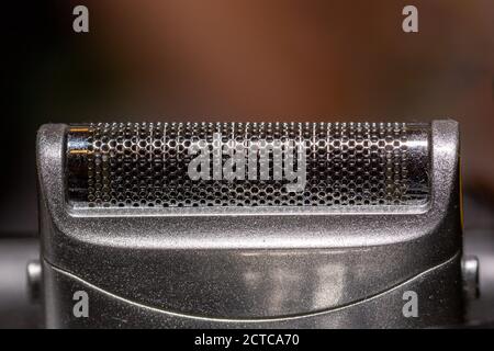 a close up of the foil of an electric shaver using selective focus Stock Photo