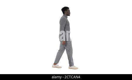Young african american man in grey casual clothes walking on whi Stock Photo