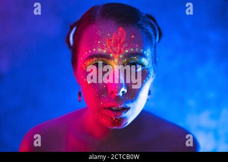 Body art on woman glowing in ultraviolet light. Art and sensuality ...
