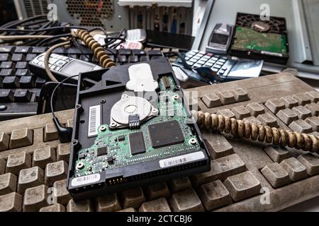 Close up on old computer hard drive on pile of electronic waste Stock Photo