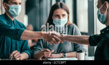 close up. business colleagues shaking hands with each other. Stock Photo