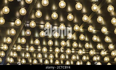 Photography of bright New Year lights at the city street in night. Christmas mood, festive atmosphere. Suitable as template and background for postcar Stock Photo