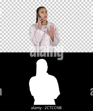 Confident female doctor, healthcare professional talking on phon Stock Photo