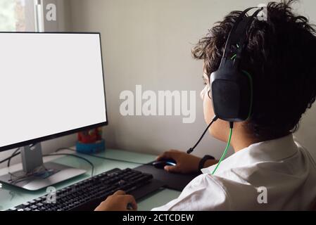 Teenager is studying at home attending online classes during the coronavirus COVID-19 Blank screen, mock-up. Madrid, Spain Stock Photo
