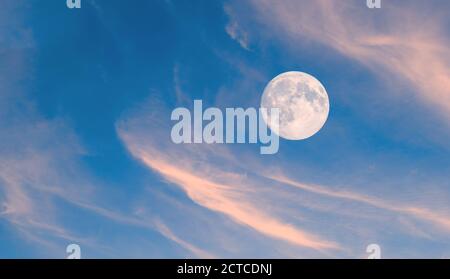 Moon over clouds as nature background. Stock Photo