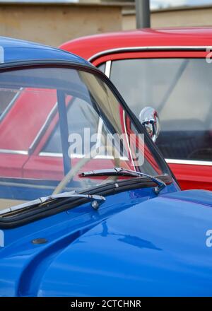 Car hood and windshield of a blue vintage car on the background of a red car close-up Stock Photo