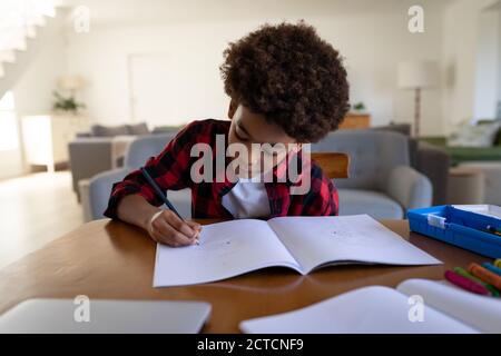Boy doing homework at home Stock Photo