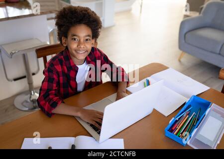 Portrait of boy using laptop at home Stock Photo