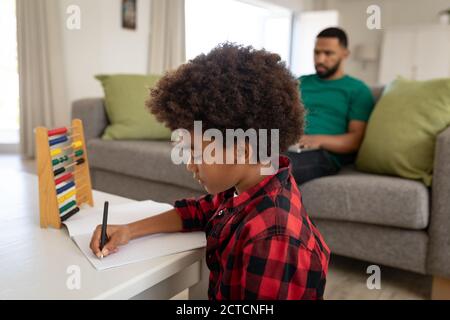 Boy doing homework at home Stock Photo