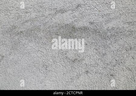 The wall is plastered with gray, coarse plaster. Stock Photo