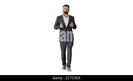Bearded turk businessman walking and talking to camera on white Stock Photo