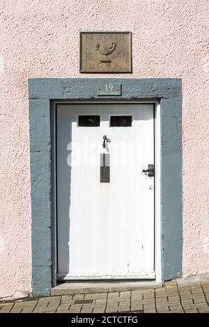 White timber front door with number 19 above. Stock Photo
