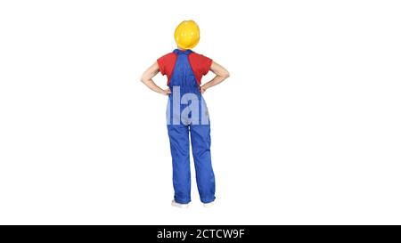 Woman engineer in construction helmet stands with hands on hips Stock Photo