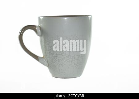 Mug with cracked walls on a white background in isolation Stock Photo