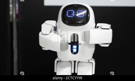 Cute humanoid robot making a move showing how strong he is. Stock Photo