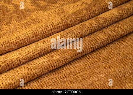Orange pleated fabric in the middle Stock Photo
