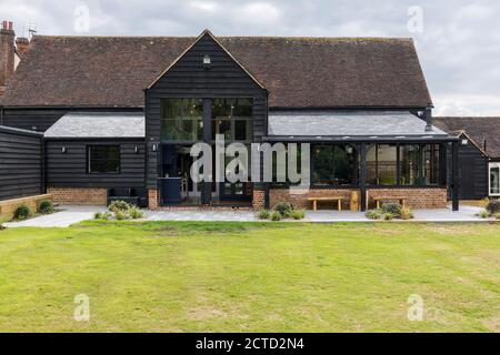 Exterior view of a converted barn/mill in Essex, UK, featuring beautful steel windows. Stock Photo