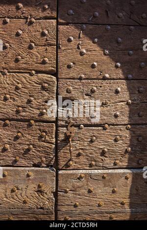 Old studded oak front door, Le Dorat, Haute-Vienne (87), France. Stock Photo