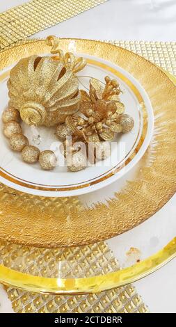 Decorated Christmas table setting. Christmas menu concept.Festive christmas, wedding, birthday table setting with golden cutlery and porcelain plate Stock Photo