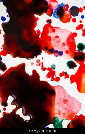 Ink drops on the paper, red, green and blue ink splashes background, painting and drawing Stock Photo