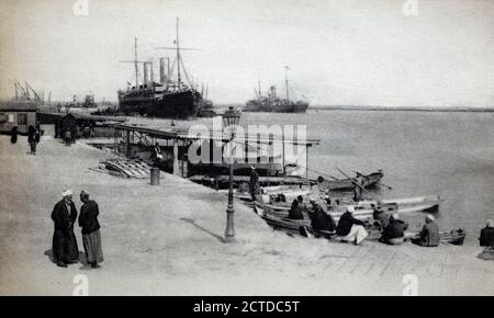 A historical view of Port Said customs quay alongside the Suez Canal, Egypt, taken from a postcard c.1900s. Stock Photo