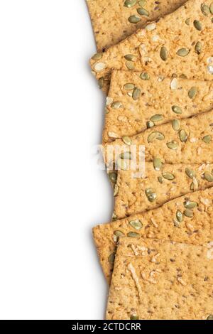 The  crispy bread with pumpkin seeds. Knackebrot isolated on white background. Stock Photo
