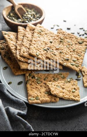 The  crispy bread with pumpkin seeds. Knackebrot on plate. Stock Photo