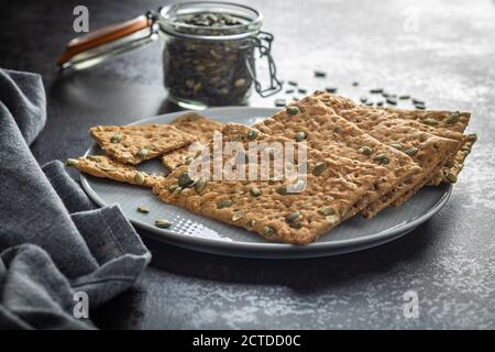 The  crispy bread with pumpkin seeds. Knackebrot on plate. Stock Photo