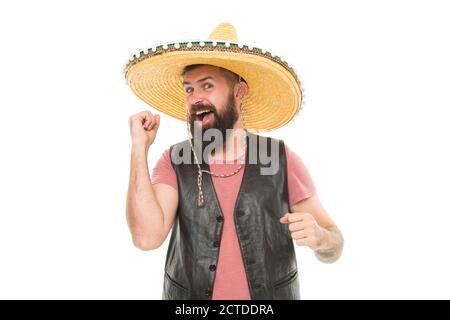 Mexican melody drives him. Man bearded cheerful guy wear sombrero mexican hat. Celebrate traditional holiday. Mexican party concept. Guy happy cheerful festive outfit ready to celebrate. Stock Photo