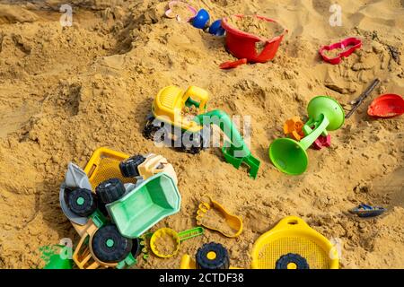 Sandpit, on a children's playground, sandpit with various toys made of plastic, excavator, shovels, molds Sauerland, NRW, Germany Stock Photo