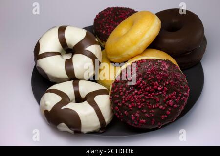 Tasty different kinds of Donuts and Berliner on White Background Stock Photo