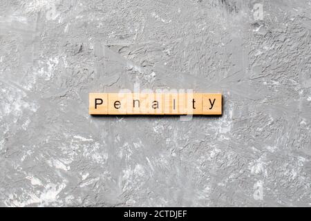 PENALTY word written on wood block. PENALTY text on cement table for your desing, concept. Stock Photo