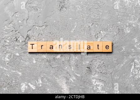 Translate word written on wood block. Translate text on cement table for your desing, concept. Stock Photo