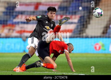 Manchester United's Harry Maguire (left) and Luton Town's Danny Hylton battle for the ball during the Carabao Cup third round match at Kenilworth Road, Luton. Stock Photo
