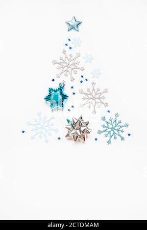 Christmas or New Year's composition 2021. Beautiful xmas tree made of blue and silver decorations on a white background and copy space. Greeting card Stock Photo