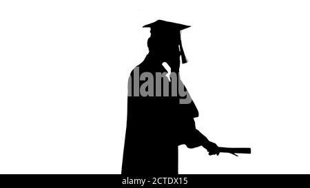 Silhouette Graduating student starts walking and making a call. Stock Photo