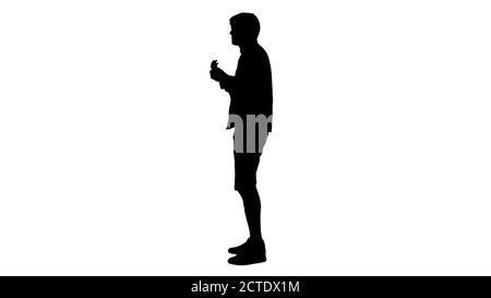 Silhouette Smiling young man playing ukulele looking into the ca Stock Photo