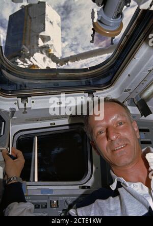 (1 Aug 1992) --- Claude Nicollier, representing the European Space Agency (ESA) onboard the Space Shuttle Atlantis for the mission, is seen on the flight deck during pre-deployment operations with the ESA's EURECA satellite.  EURECA can be seen on the end of the Remote Manipulator System (RMS).  Nicollier was joined by five NASA astronauts and an Italian payload specialist for eight days aboard the Atlantis. Stock Photo