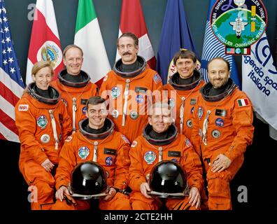 (May 1992) --- The crew members assigned to the STS-46 mission pose with seven flags that represent participation on the flight. Loren Shriver (right front) is mission commander; Andrew Allen (left front) is pilot. Others are (left to right) Marsha Ivins, mission specialist; Claude Nicollier, mission specialist representing the European Space Agency (ESA); Jeffrey Hoffman, payload commander; Franklin Chang-Diaz, mission specialist; and Franco Malerba, flying for the Italian Space Agency (ASI). The flags, left to right, represent the United States of America, Costa Rica (Chang's native country) Stock Photo