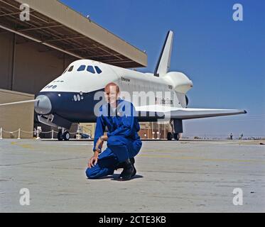 (17 Sept 1976) --- Astronaut C. Gordon Fullerton, pilot of the first crew for the Space Shuttle Approach and Landing Tests (ALT), is photographed at the Rockwell International Space Division's Orbiter assembly facility at Palmdale, California on the day of the rollout of the Shuttle Orbiter 101 'Enterprise' spacecraft. The DC-9 size airplane-like Orbiter 101 is in the background. Stock Photo