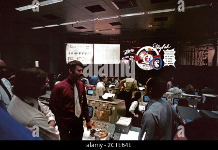 (8 Feb. 1974) --- An overall view of activity in the Mission Operations Control Room in the Mission Control Counter following the successful splashdown of the Skylab 4 command module in the Pacific Ocean. The three flight controllers in the foreground, left to right, are flight director Neil B. Hutchinson; flight director Donald R. Puddy; and astronaut Robert L. Crippen, a spacecraft communicator (CAPCOM). Stock Photo