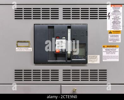 Main power breaker in electrical room of residential or commercial building. Insulated case circuit breaker with pump handle and bell. Stock Photo