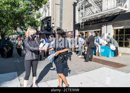 New York, NY - September 22, 2020: Census 2020 employee distributes flyers to New Yorkers at Sylvia's Restaurant in Harlem during Census Drive Stock Photo