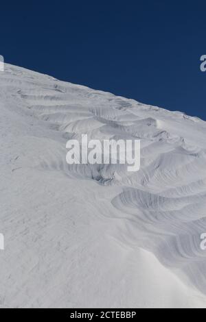 Natural patterns and ridges in windswept snow Stock Photo
