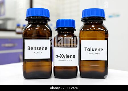 Selective focus of benzene, toluene and xylene liquid chemical compound in glass amber bottle inside a chemistry laboratory with copy space. BTX aromatic hydrocarbons. Stock Photo