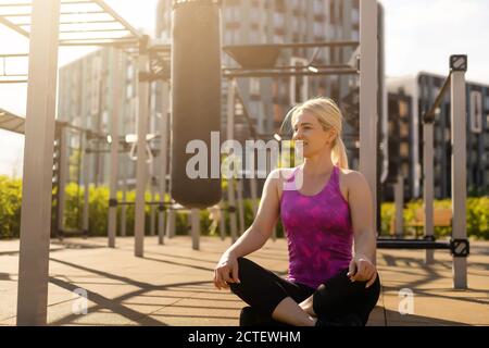 A sport girl in fashion sportswear doing fitness exercise in the street,  outdoor sports, urban style Stock Photo