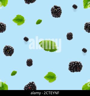 Falling Bramble Seamless pattern. Fresh Falling blackberry seamless pattern. Pattern with fresh wild berries isolated on blue background. Stock Photo