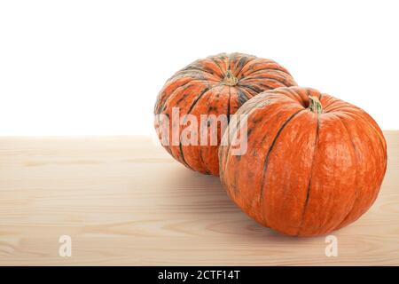 pumpkin agriculture. two pumpkins on a wooden table on a white background isolated Stock Photo